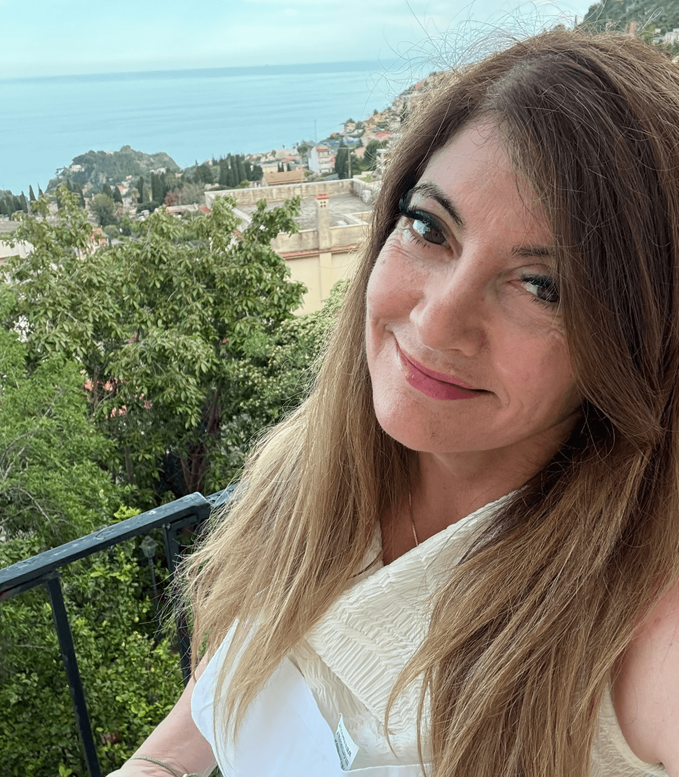 Woman smiling with ocean view background