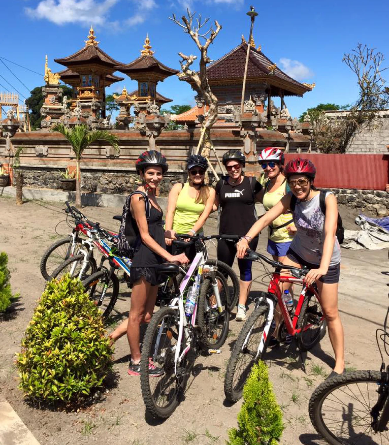 Group biking near traditional Asian architecture